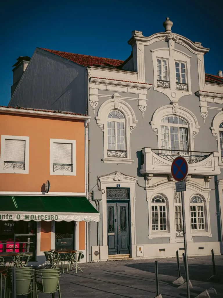 Colorful facade of traditional houses in Aveiro, Portugal, under a clear blue sky.