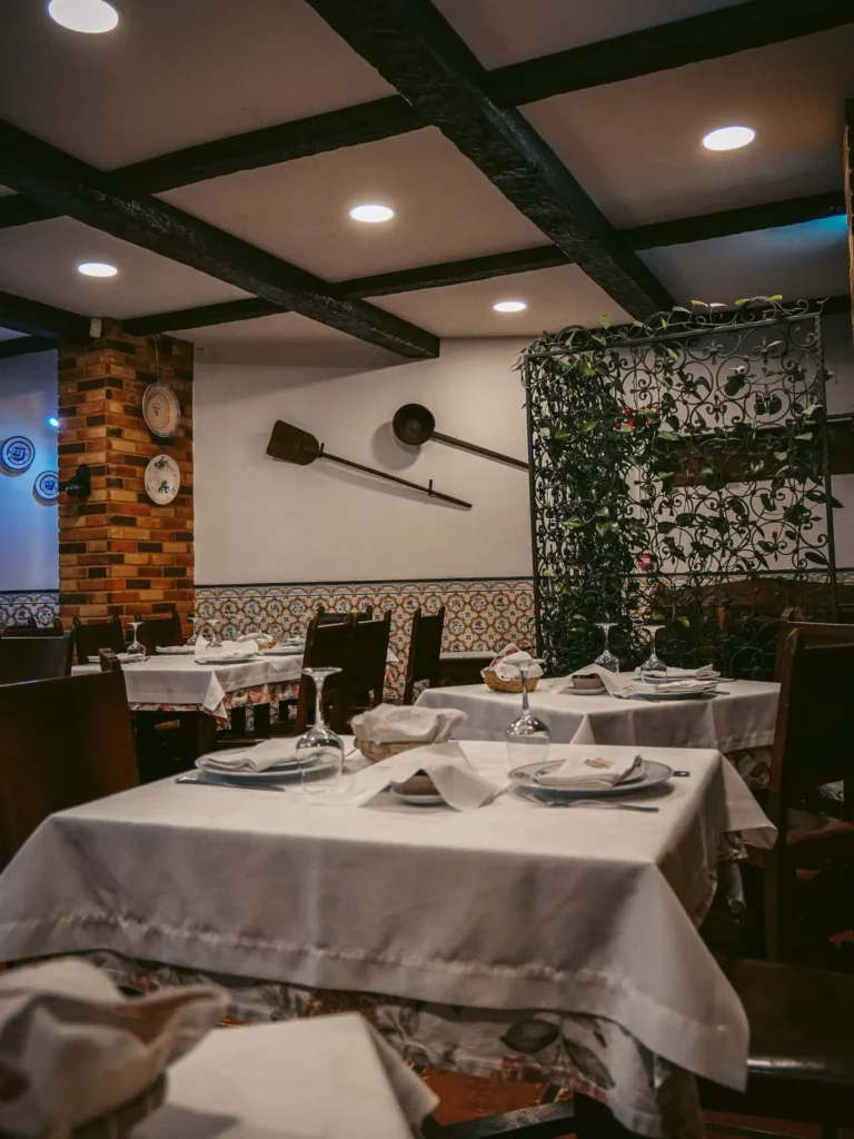 Adega Típica restaurant in Aveiro, set tables, warm and rustic atmosphere.  
---  
Bacalhau com natas golden dish, served in a typical restaurant in Aveiro, warm and friendly atmosphere.  
---  
Creamy bacalhau com natas dish at Adega Típica, Aveiro, warm and friendly atmosphere.