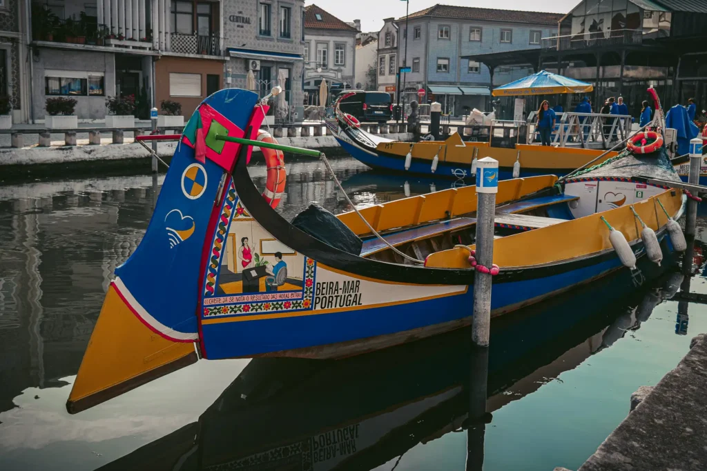 Colorful moliceiros moored on a canal in Aveiro, Portugal, peaceful and picturesque atmosphere.
