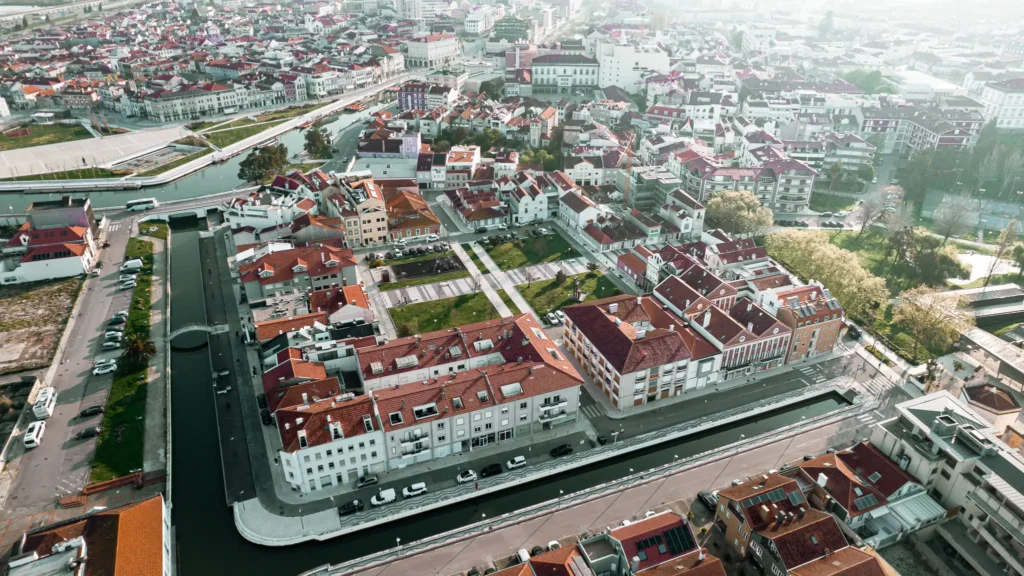 Aerial view of Aveiro, Portugal, showing the picturesque canals and red roofs of historic buildings.