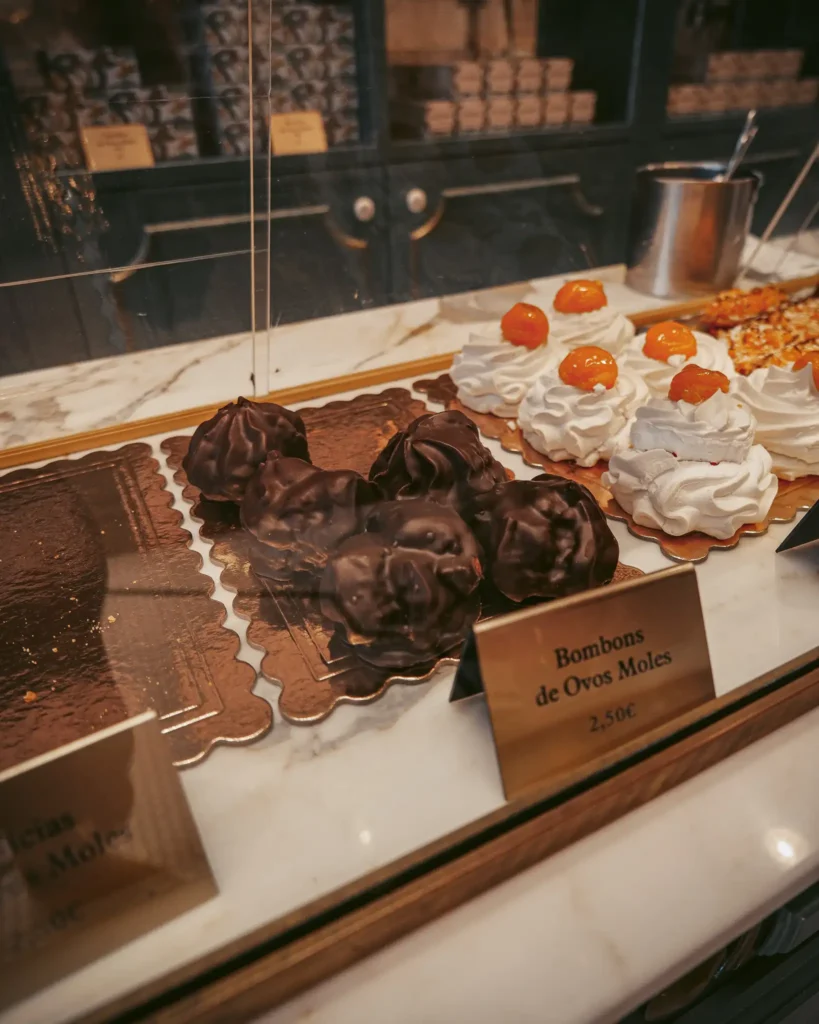 Traditional pastries at Confeitaria Peixinho, Aveiro, Portugal, warm and indulgent atmosphere.