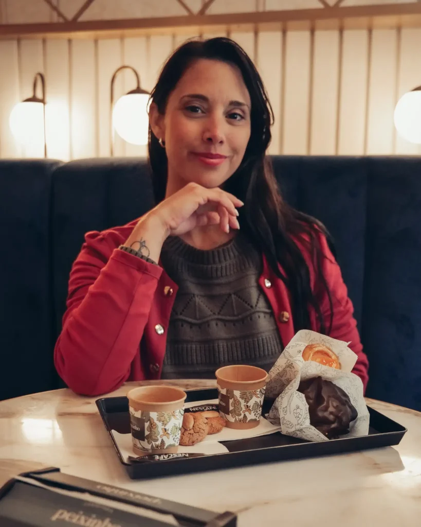 Caroline enjoying traditional pastries at Confeitaria Peixinho, Aveiro, Portugal.