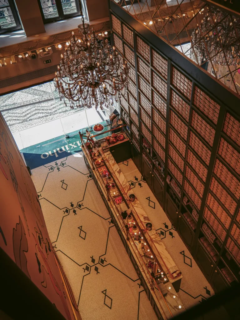 Interior of Confeitaria Peixinho in Aveiro, Portugal, aerial view of the counter and elegant chandelier.