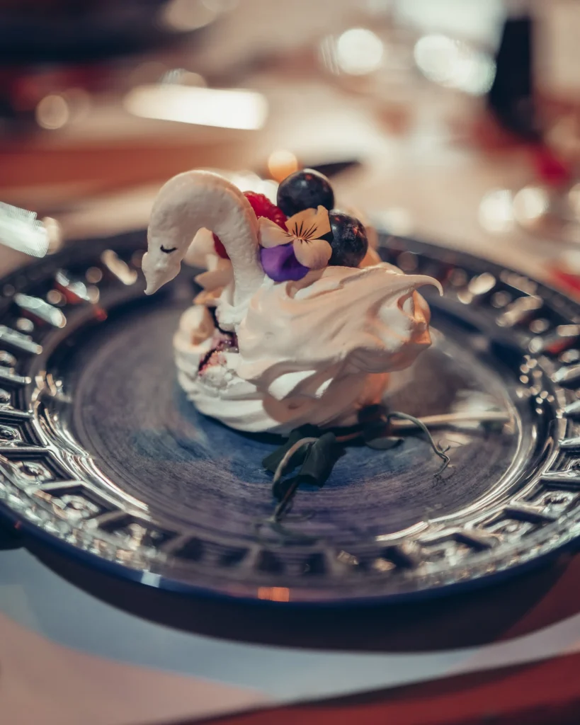 Swan-shaped dessert at Sushi na Gaveta restaurant, Tavira, Algarve, Portugal, on an elegant blue plate.