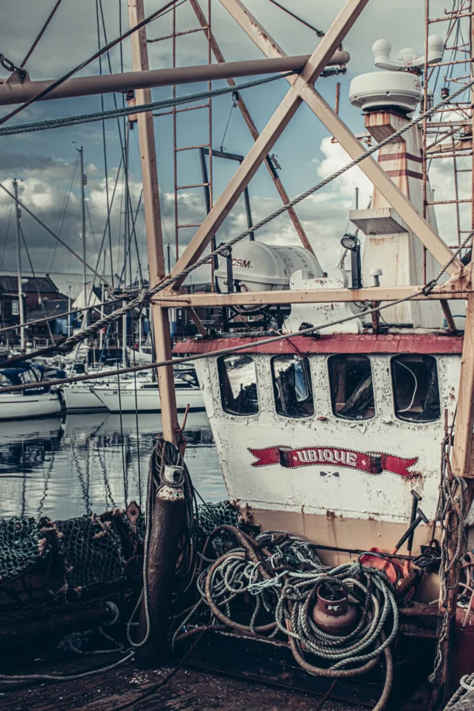 Fishing boat moored in the port of Arbroath surrounded by nets and ropes