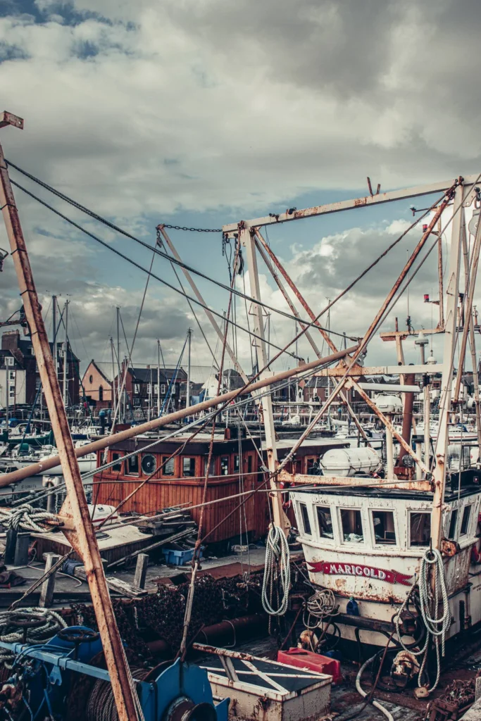 Fishing boats moored in the harbor of Arbroath under a cloudy sky