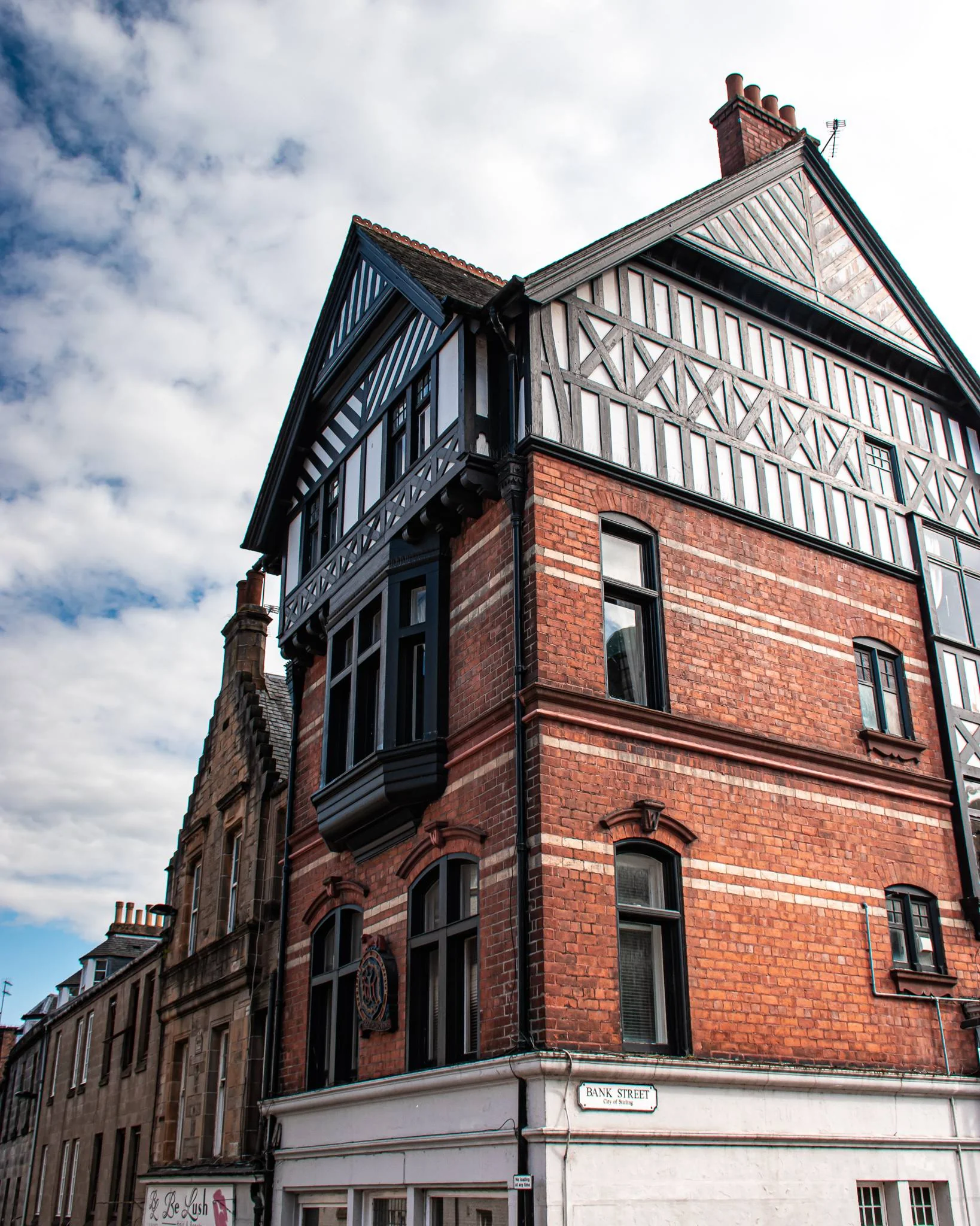 Timber-framed building with red bricks at the corner of Bank Street in Stirling