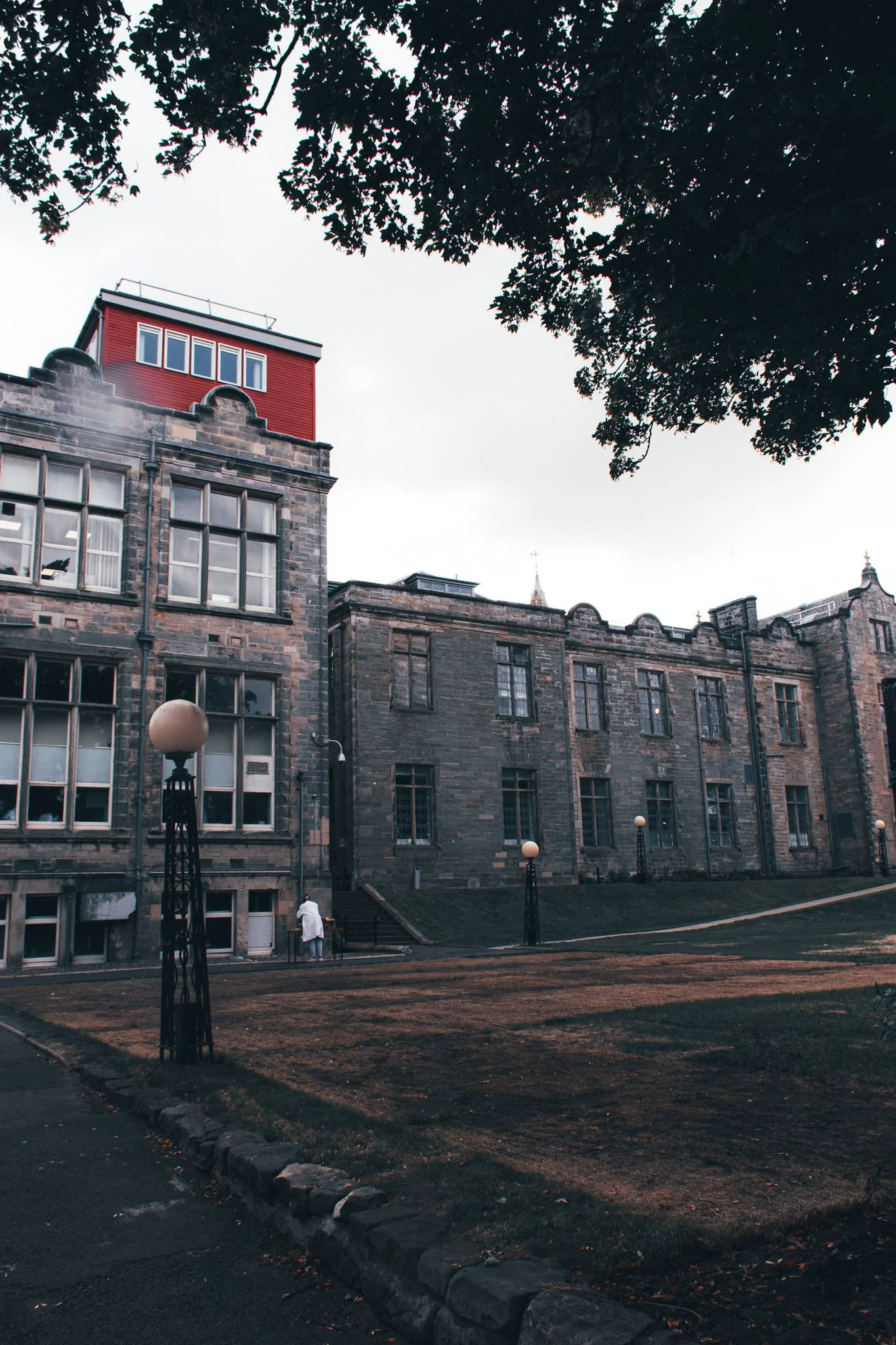 Stone university-style building in St Andrews with lawn