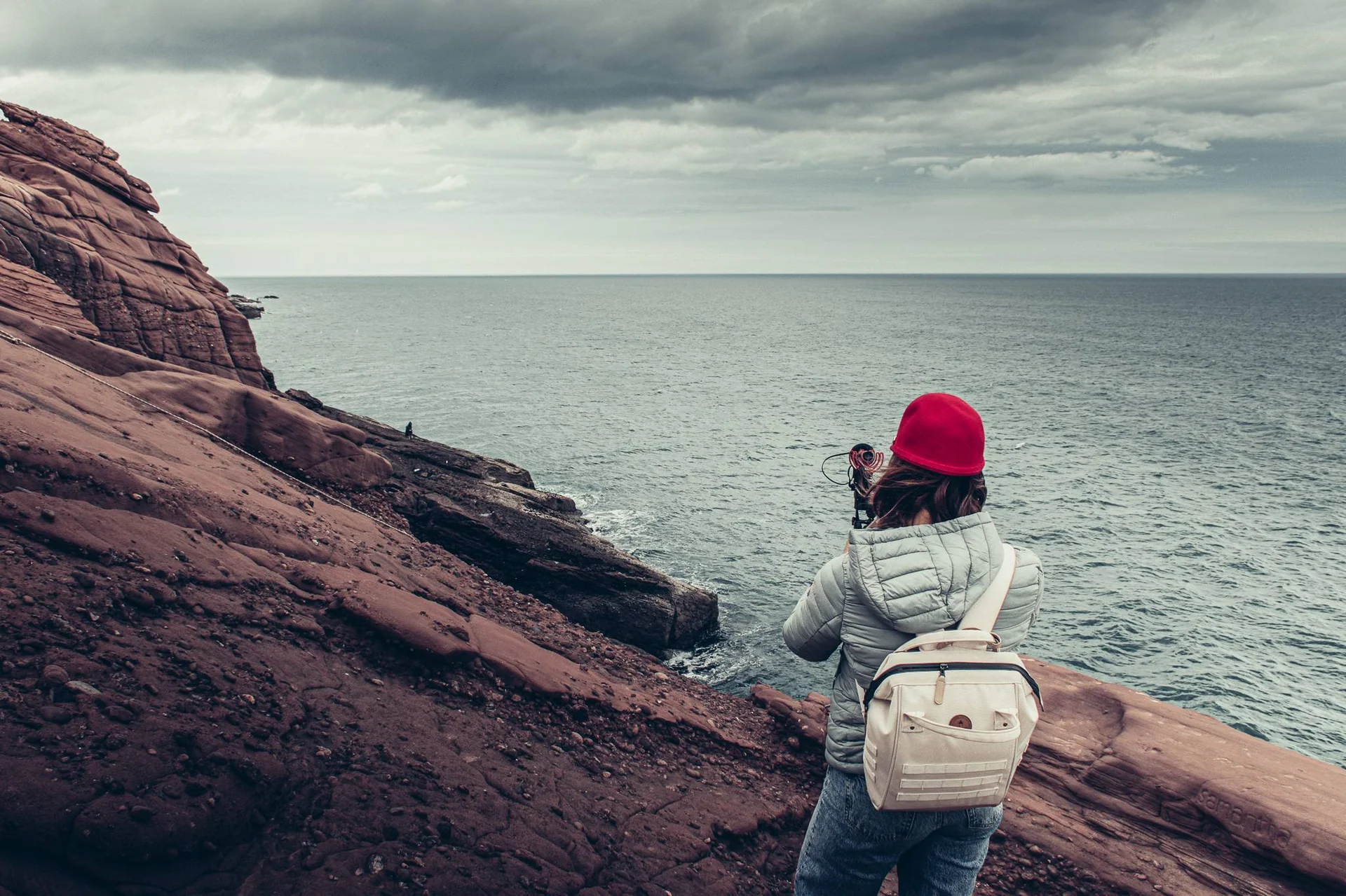 Caroline photographs the red cliffs overlooking the North Sea in Arbroath