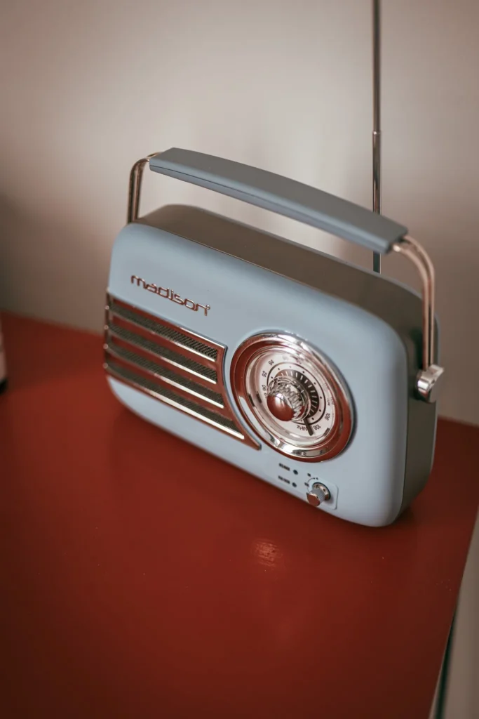 Vintage radio from the Madison brand placed on a red table, retro atmosphere in an interior in Fuseta, Algarve.