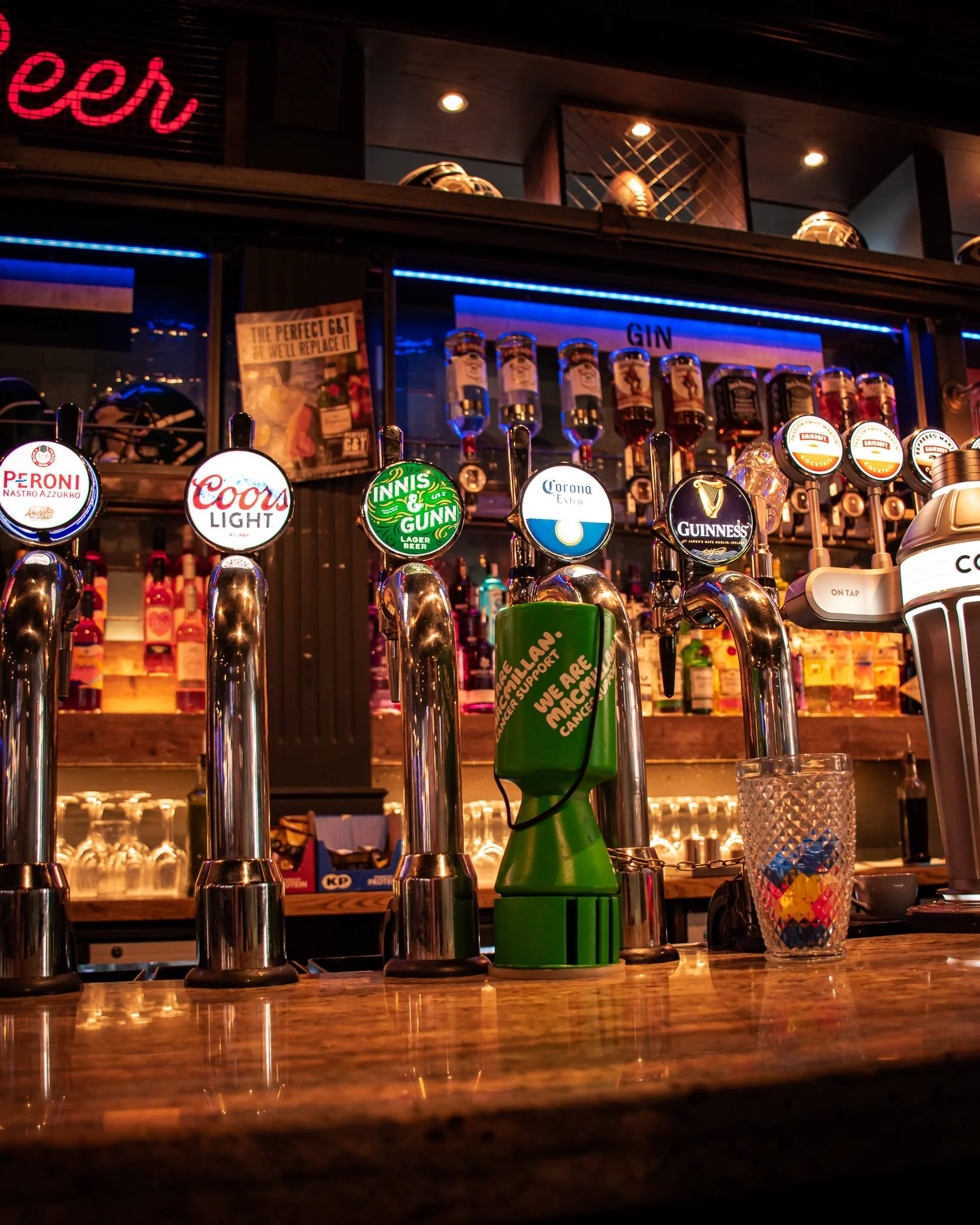 Bar counter in Stirling with several beer taps and bottles of alcohol