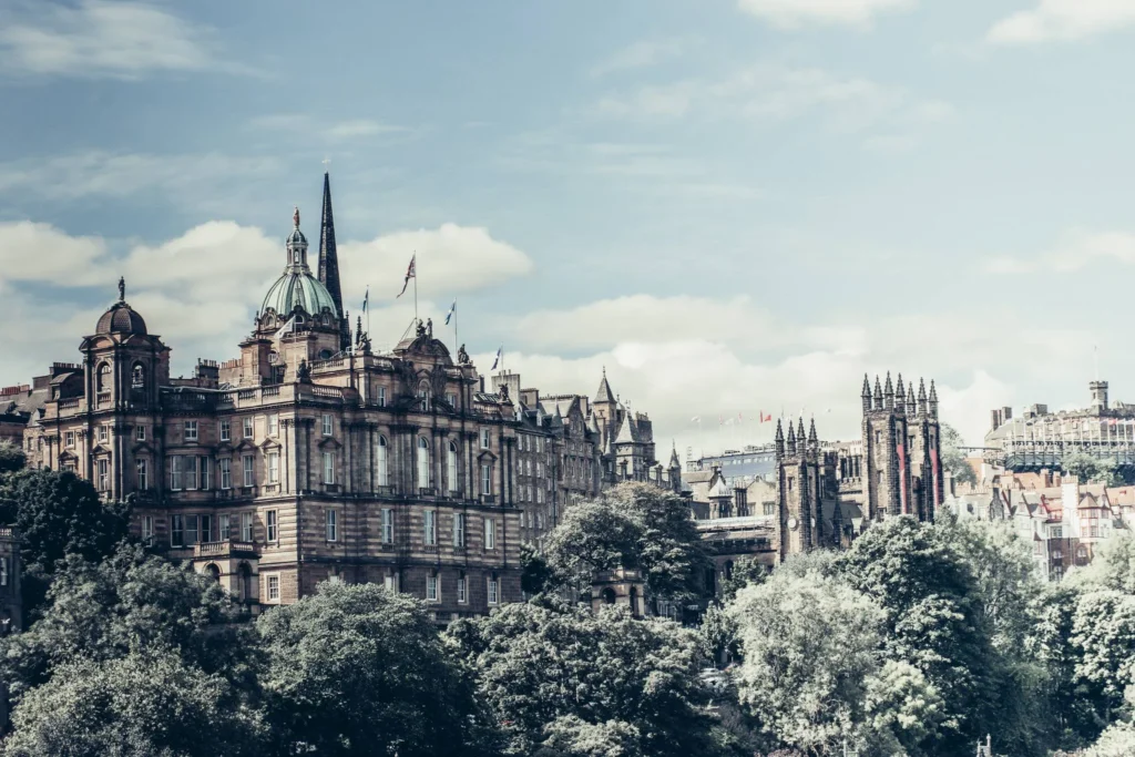 Panoramic view of Edinburgh's historic landmarks under a partly cloudy sky