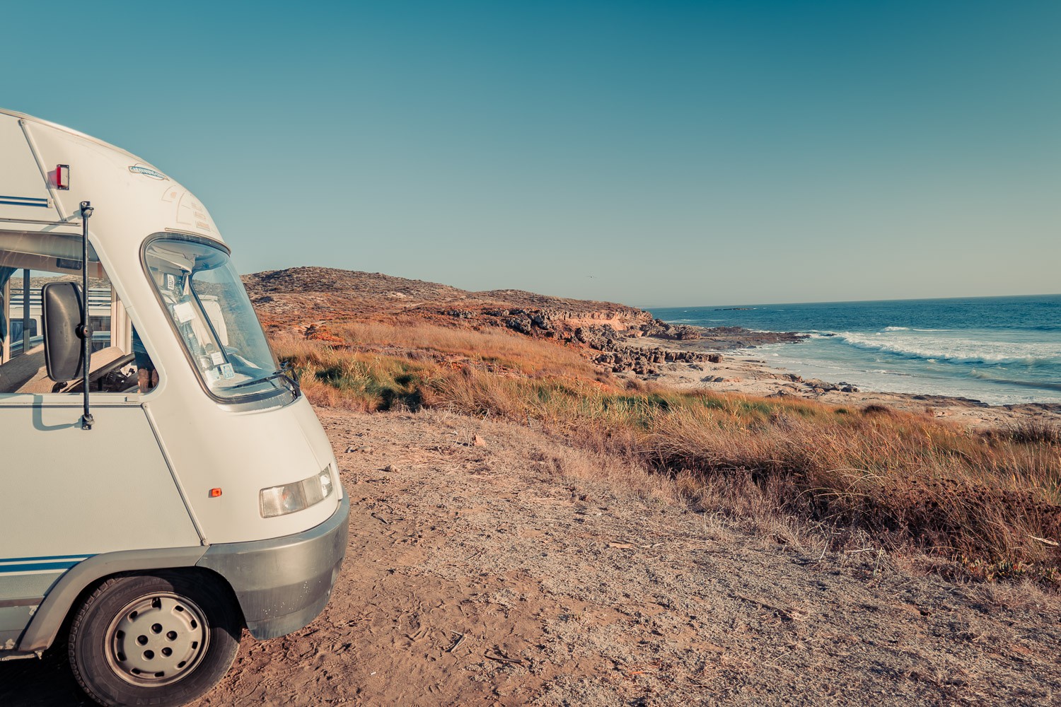 Camper van Edouard is parked facing the Atlantic Ocean on a wild coast, ideal for renting out your van when you're not using it.