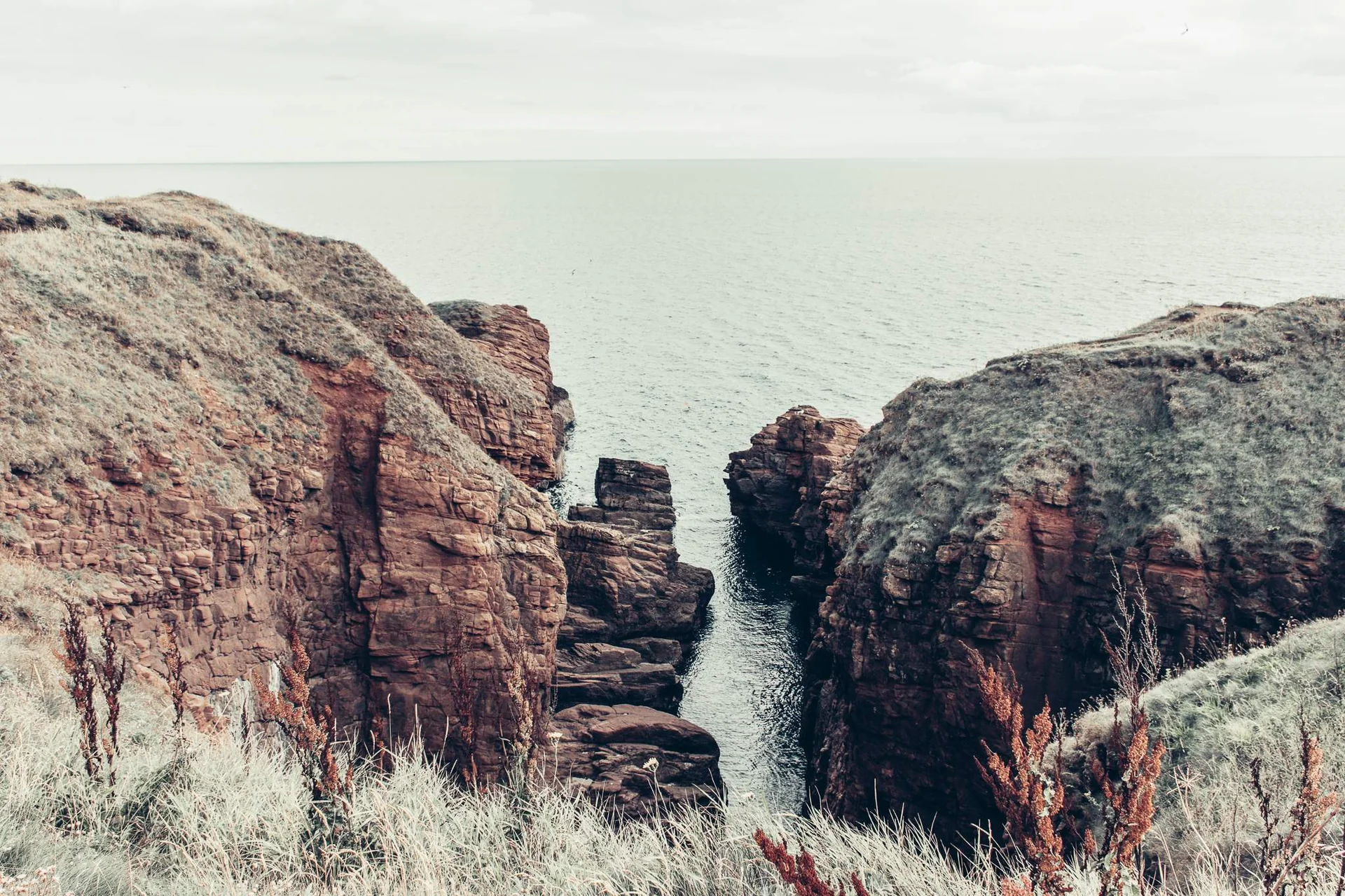 Red sandstone cliffs overlooking the North Sea near Arbroath, Scotland