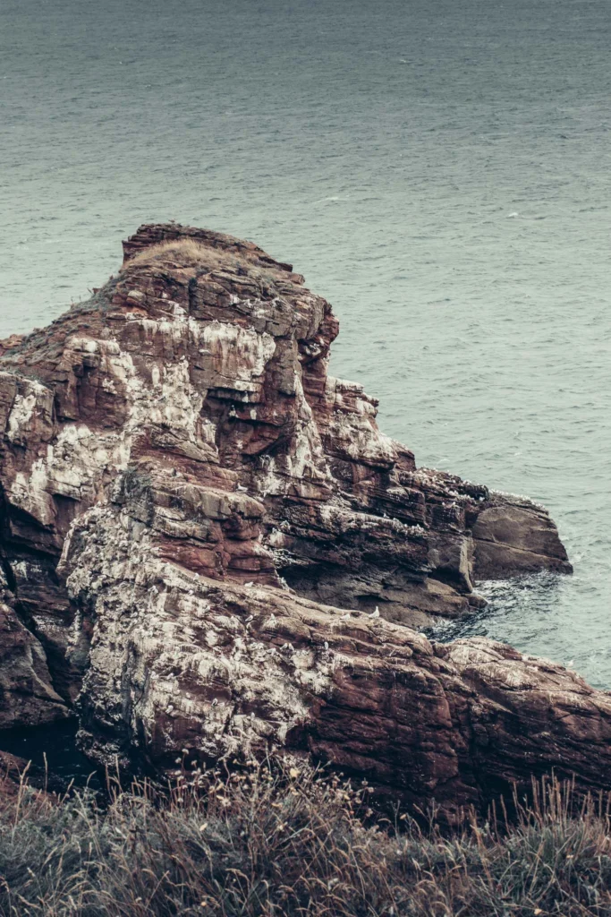 Rocky cliffs of Arbroath overlooking the sea under a Scottish grey sky