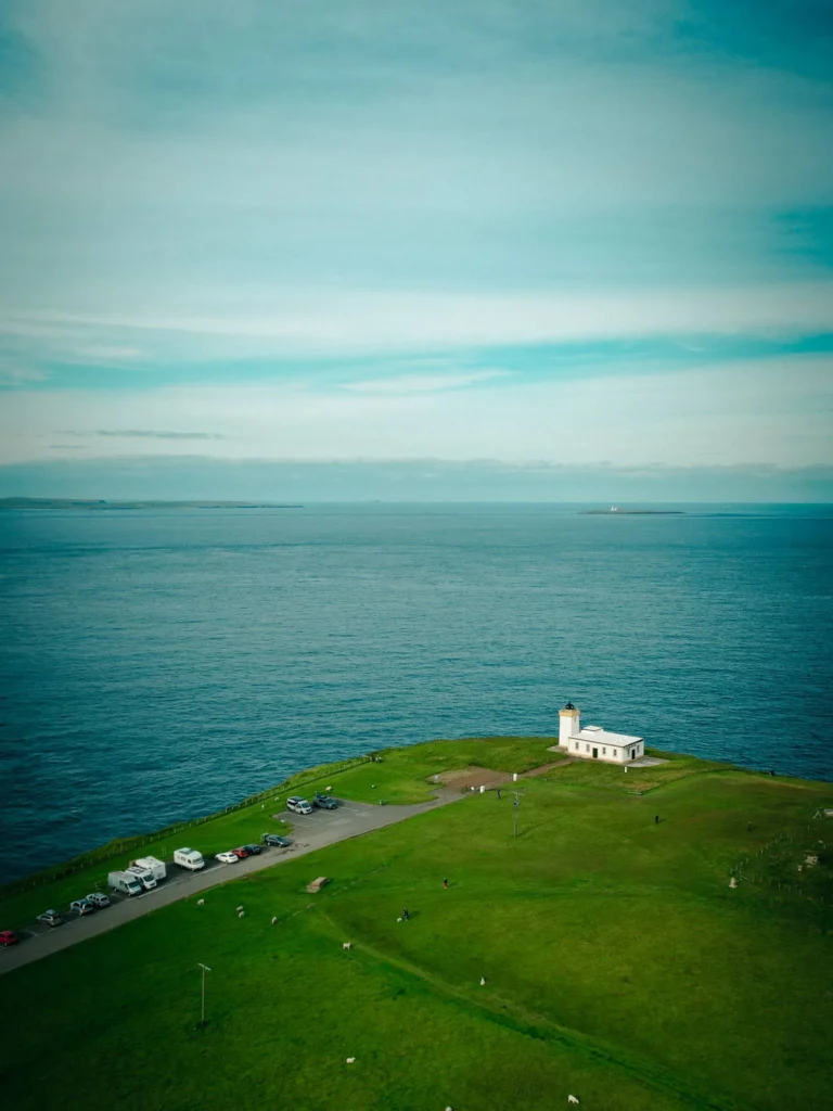 Aerial view of John O'Groats coastal point isolated white lighthouse