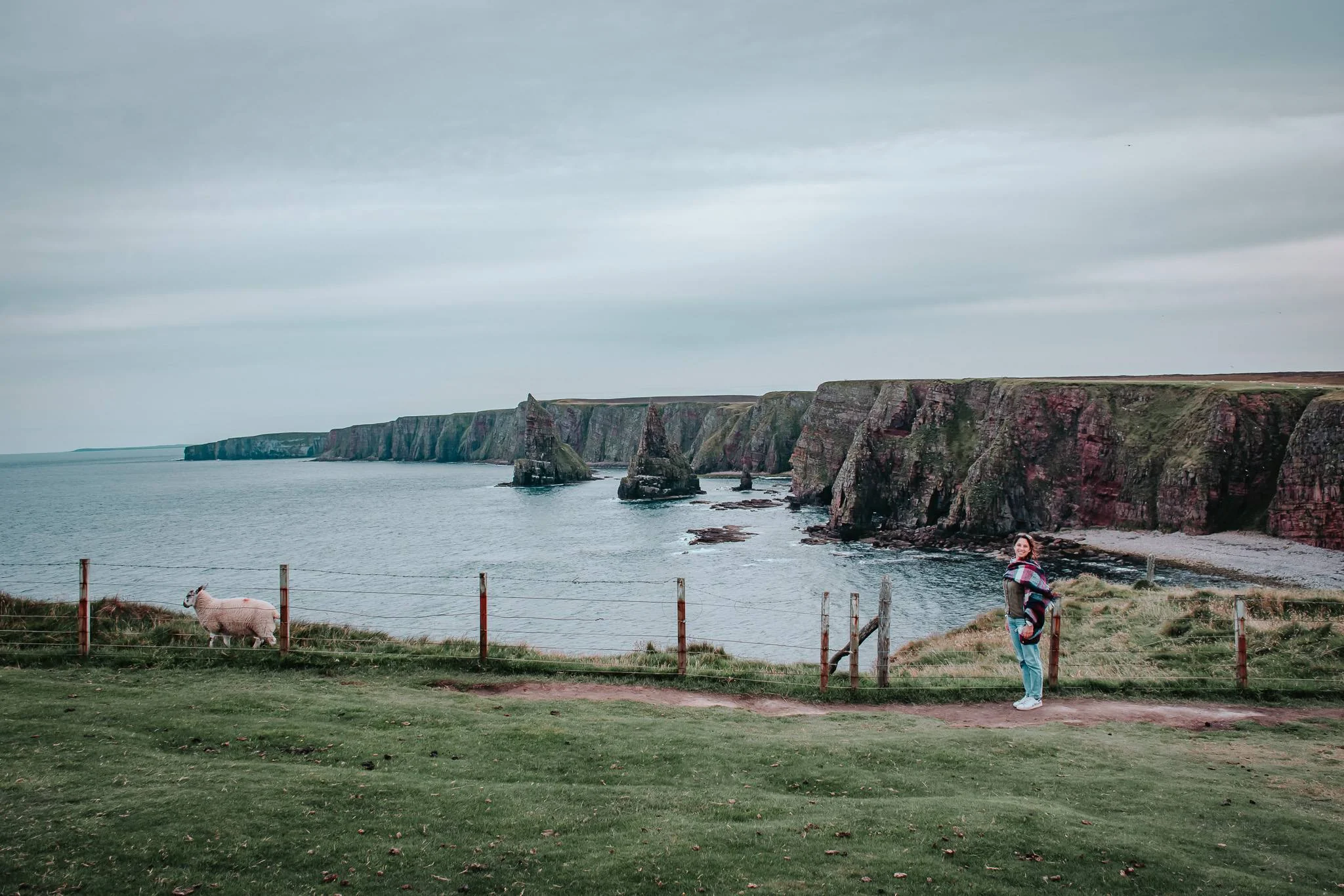 Caroline facing the cliffs of John O'Groats wind and sea