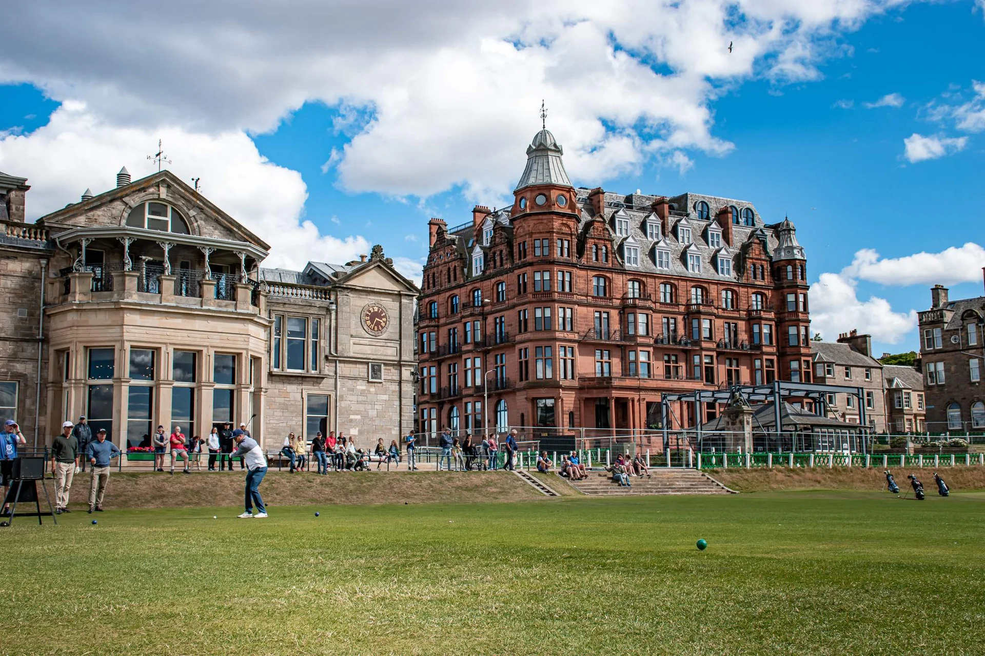 View of the famous Old Course in St Andrews with golfers and historic buildings