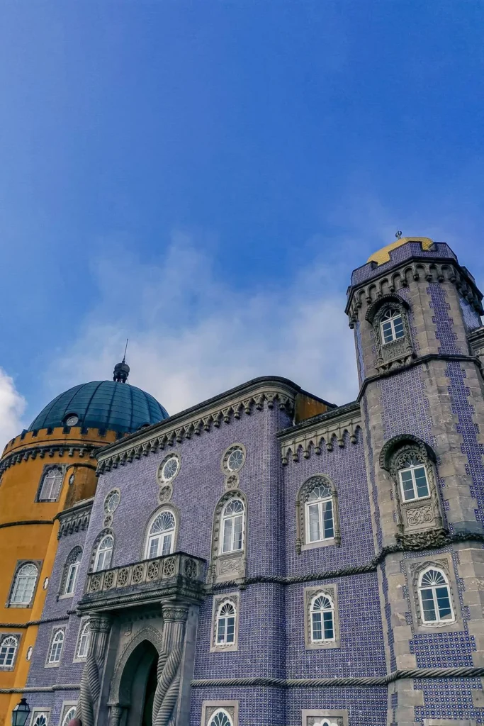 Colorful facade of the National Palace of Pena in Sintra, Portugal, photographed under a blue sky in February 2022.