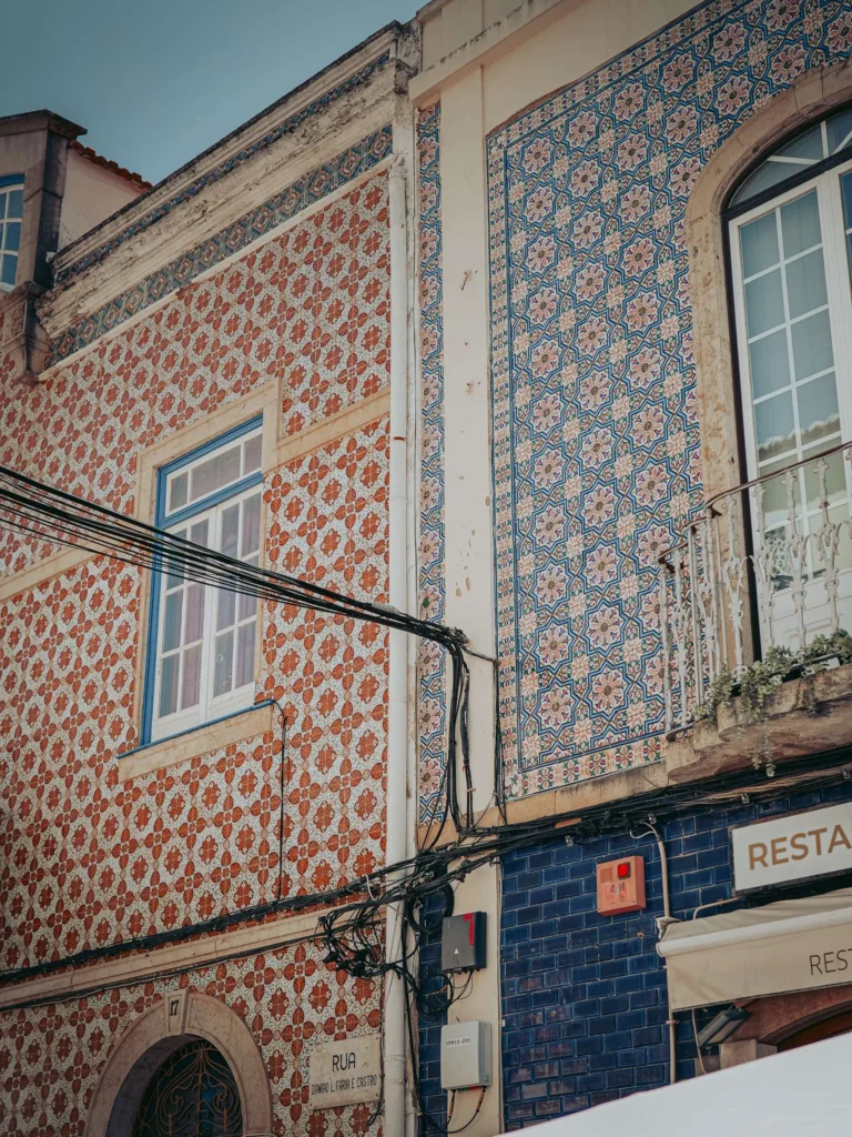 Building facades covered with colorful azulejos in Portimao, Algarve, Portugal, photographed in May 2026.
