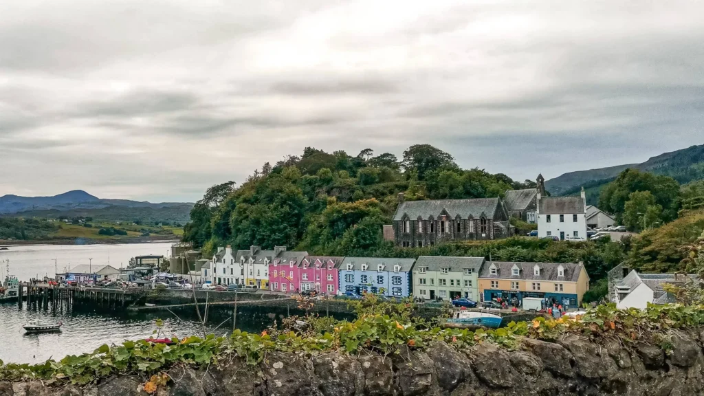Colorful houses Portree with green hill Isle of Skye