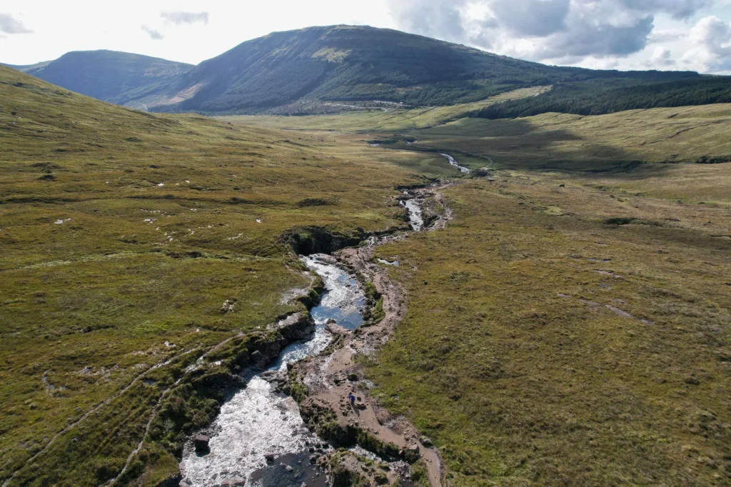 Aerial view of the Fairy Pools with a river winding through a lush valley on the Isle of Skye