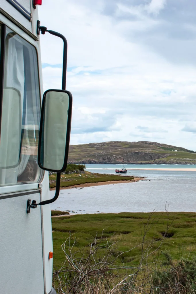 Motorhome by the coast, water expanse, hills in the north of Scotland