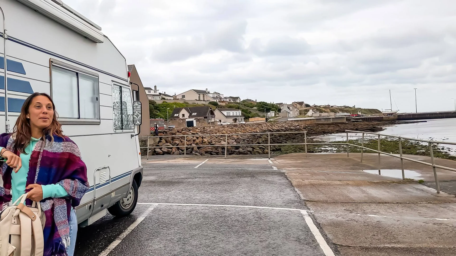 Caroline in front of a camper van parked near the port of Wick in Scotland