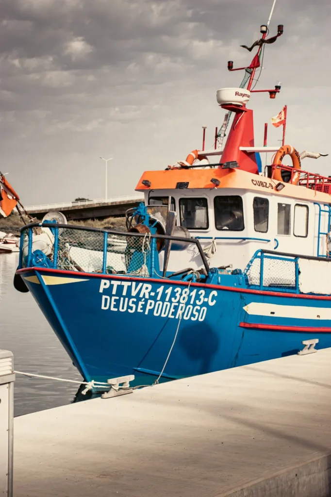 Blue and orange fishing boat in Tavira harbour