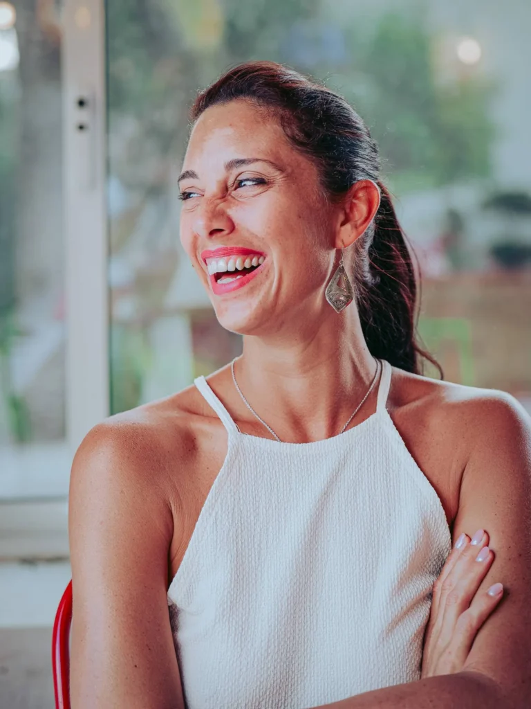 Caroline smiles in the bright interior of Lumo restaurant in Tavira, Algarve, in June 2026.