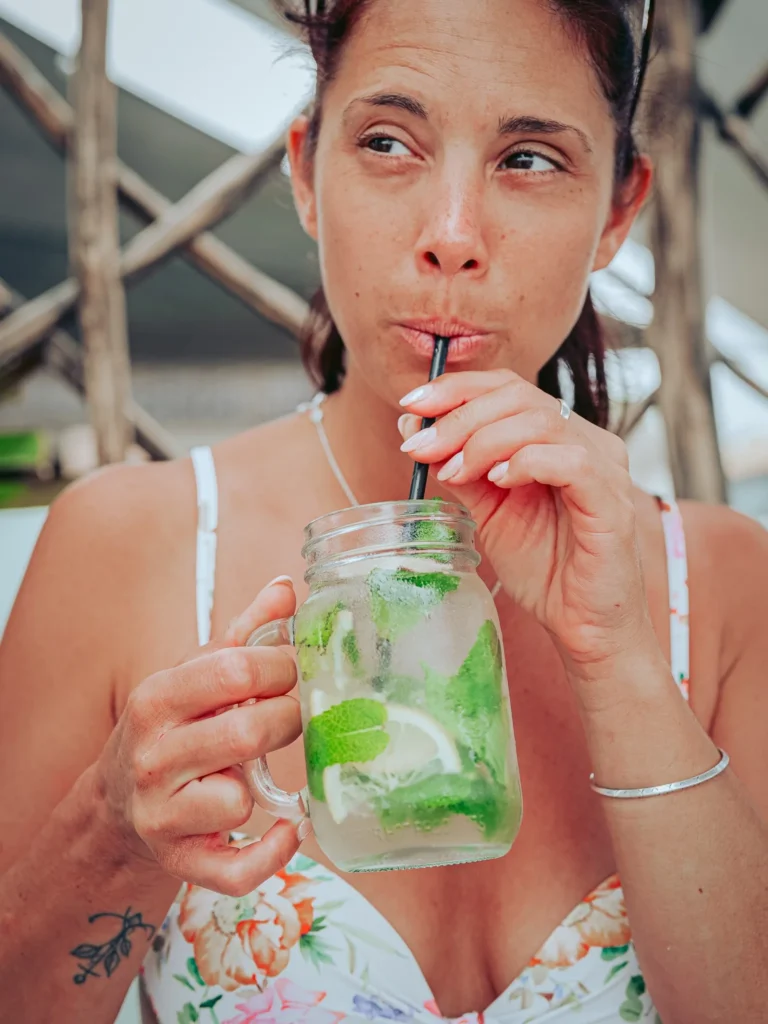 Caroline is drinking a ginger and mint lemonade on the island of Tavira, in the Algarve, on a summer day.