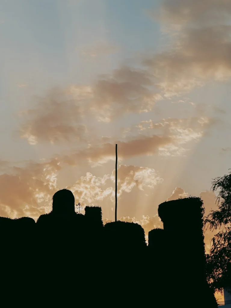 Silhouette of the ramparts of Fort São Clemente at sunset in Vila Nova de Milfontes, cloudy sky in the background, fortress overlooking the mouth of the Mira, in Alentejo.