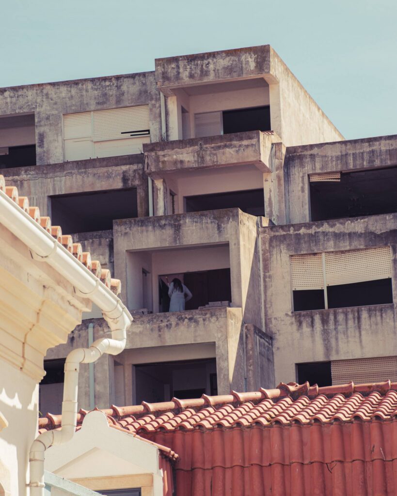 Abandoned building in Albufeira with a silhouette on the balcony