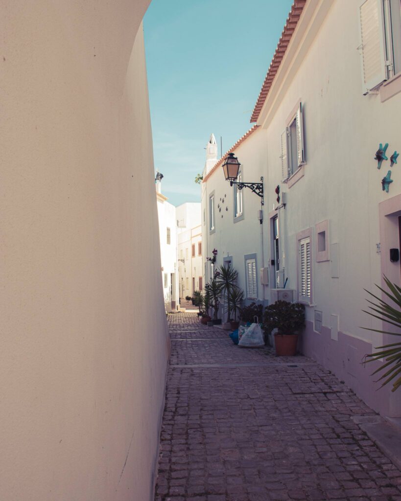 Narrow alley with typical white houses of the Algarve in Albufeira