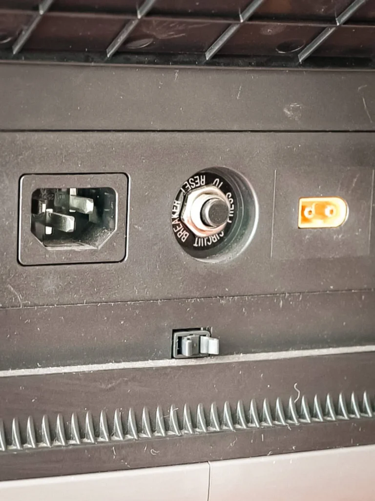 Entry ports of the AllPowers R2500: mains charging socket, resettable circuit breaker, and proprietary solar input (orange connector).