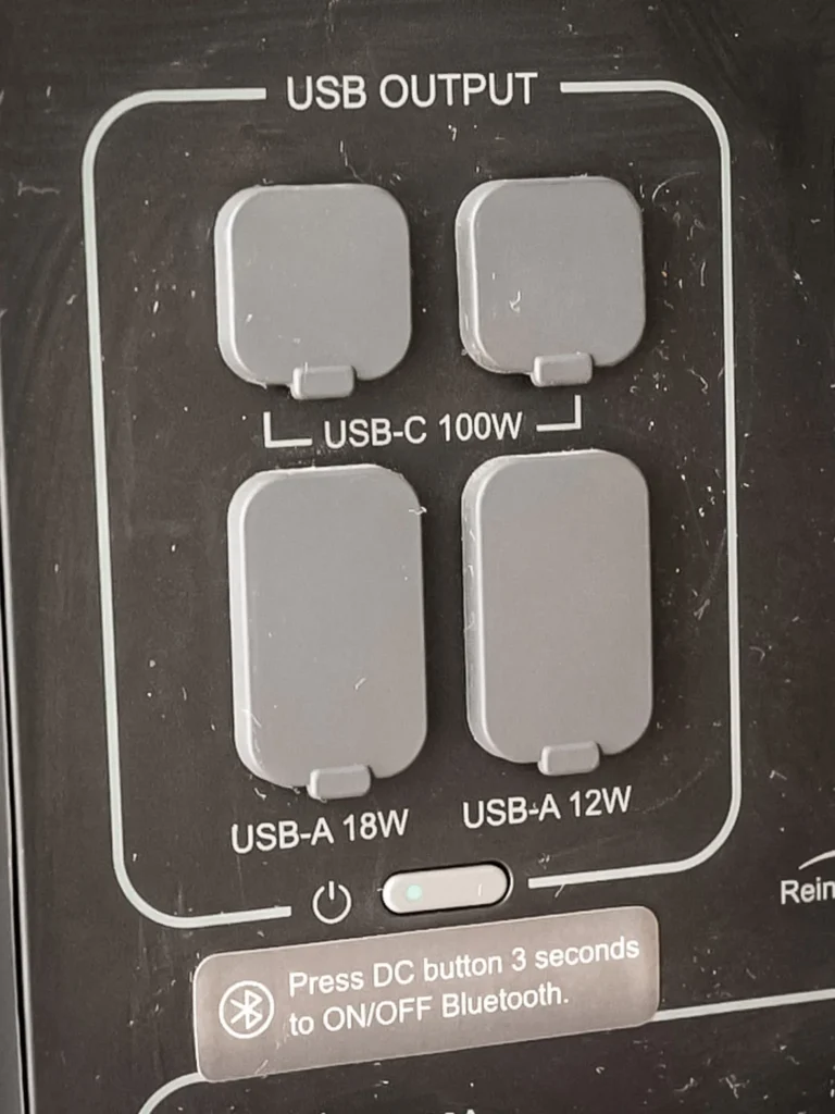 Close-up of the AllPowers R2500 USB outputs: two 100W USB-C ports and two USB-A ports (18W and 12W), each protected by a silicone cover.