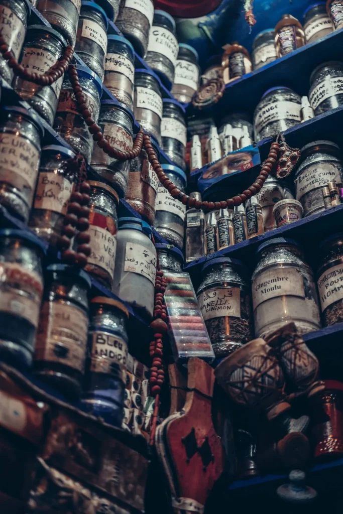 Shelves filled with jars of herbs, spices, and traditional remedies in a herbalist shop in Essaouira, authentic and colorful atmosphere.