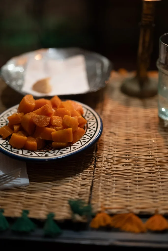 Carrot plate with spices served on a wicker table in a restaurant in Essaouira, warm atmosphere.