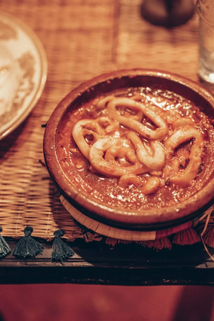 Seafood tagine served on a wicker table at Tagna 8 restaurant in Essaouira, Morocco, on October 22, 2025.