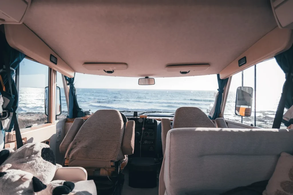 Interior view of a camper van parked facing the Atlantic Ocean at Praia de Oliveirinha near Porto Covo, Alentejo, Portugal, in summer 2024.