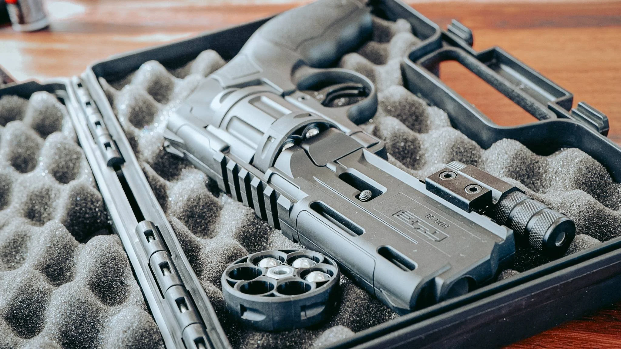 HDR 50 defense pistol stored in its foam case with cylinder and laser module