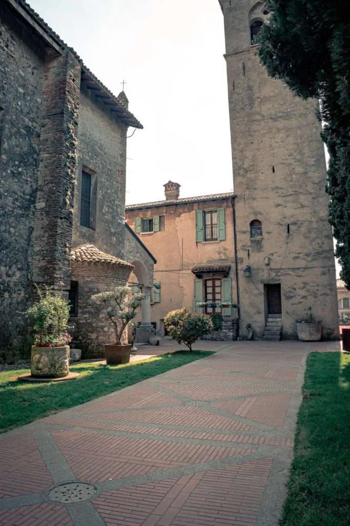 Peaceful inner courtyard in Sirmione surrounded by old stone buildings