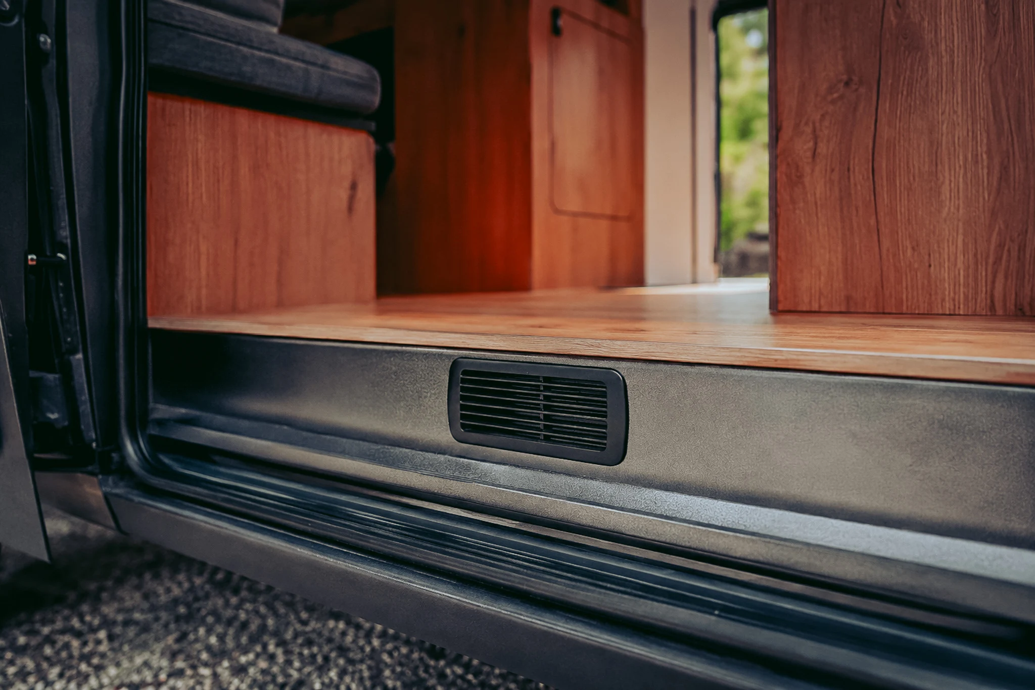 Low ventilation grille installed on the step of the sliding door of a converted van