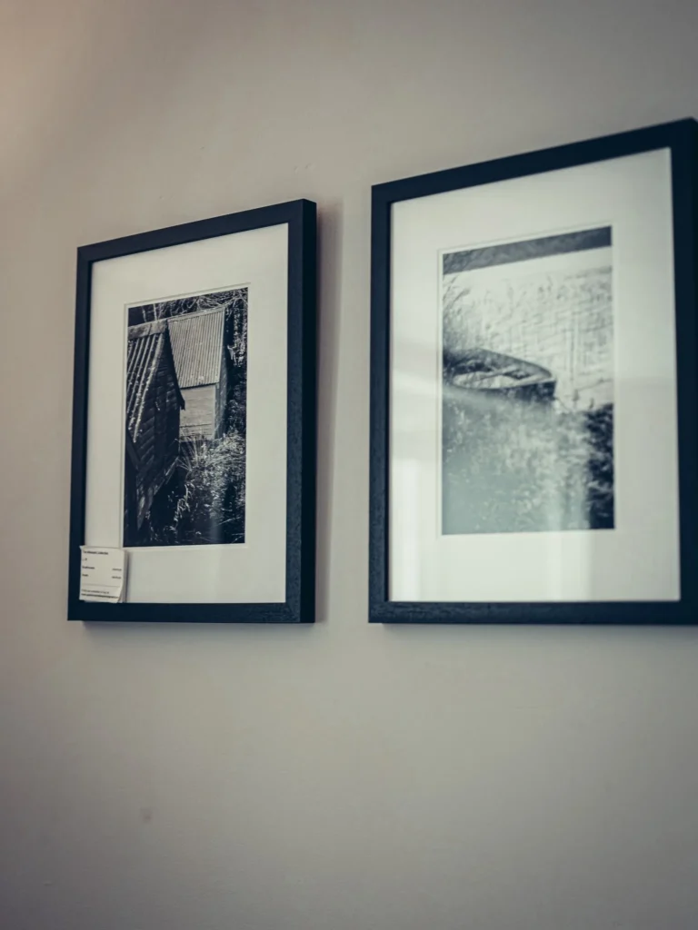 Two framed black and white photographs are hanging on a wall in a room at the Allan Park Hotel in Stirling, Scotland, in August 2026.