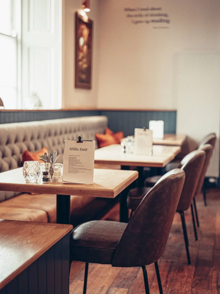 Restaurant room of the Allan Park Hotel in Stirling, Scotland, tables set with menus and natural light during the day.