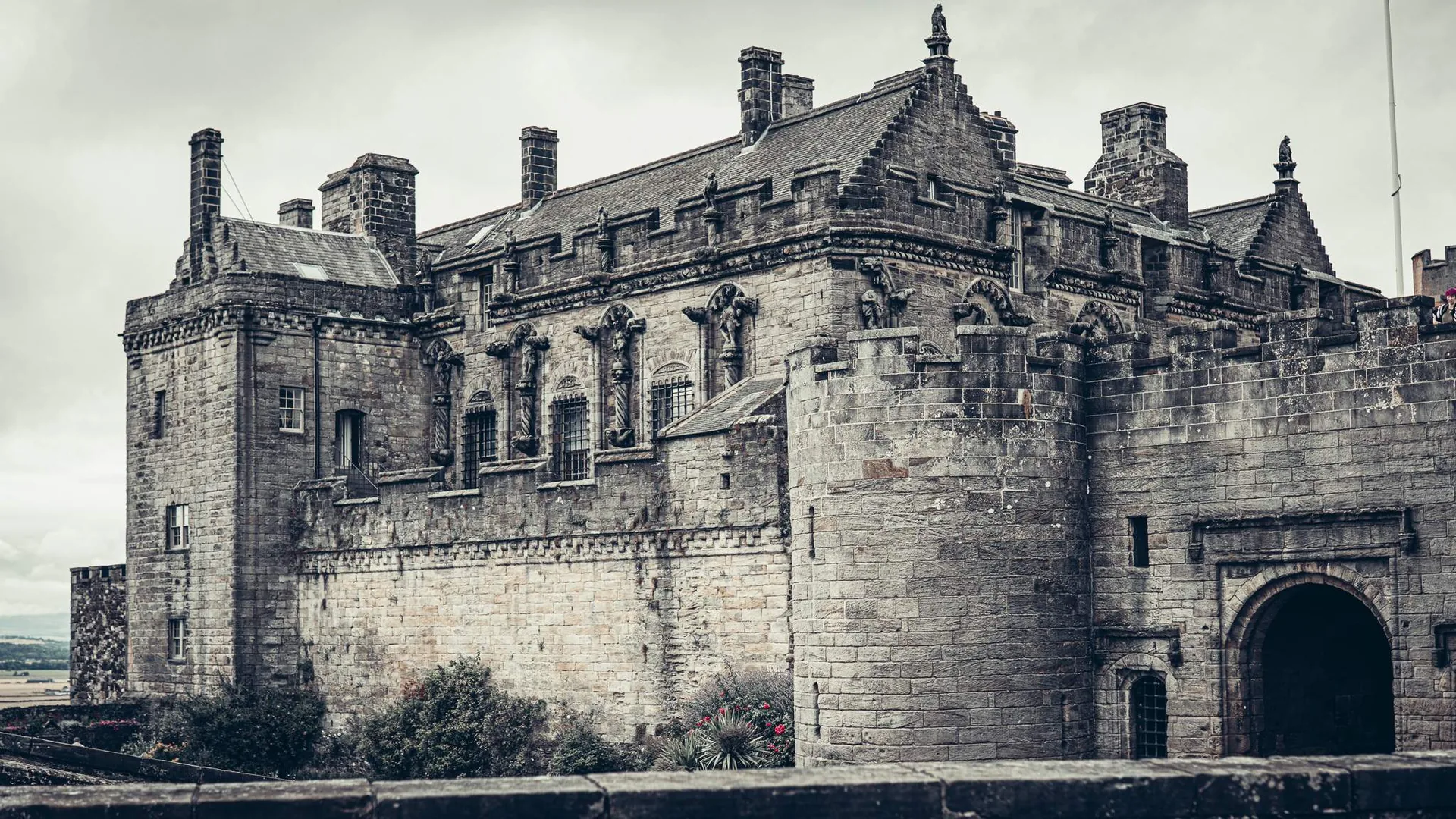The main front of Stirling Castle, Scotland, looking towards the ramparts and the entrance under a cloudy sky in August 2026.