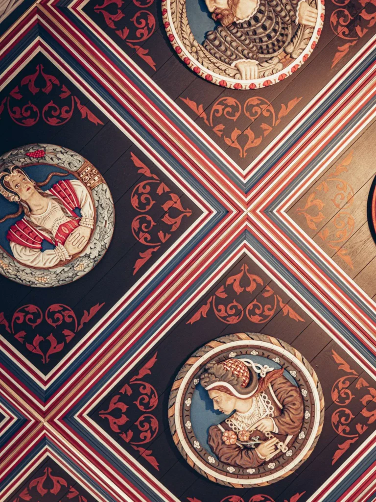 A ceiling set with painted roundels carved as portrait heads, inside the royal apartments at Stirling Castle, Scotland, on 16 August 2026.
