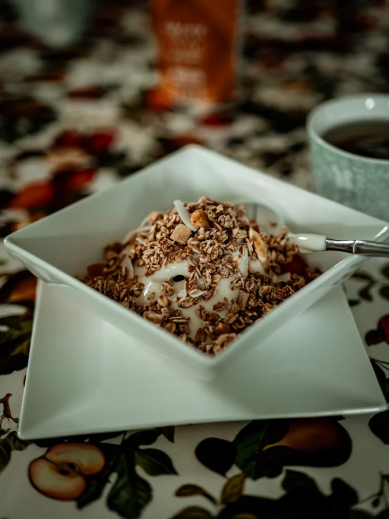 Yoghurt bowl with granola served on a fruity patterned table, typical of a breakfast at Rocklee Bnb in the Scottish Highlands.