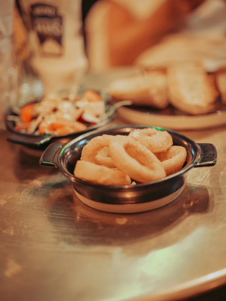 Fried squid plate on a pub table in Stirling, with a salad and bread in the background. Dish not documented in the vault.