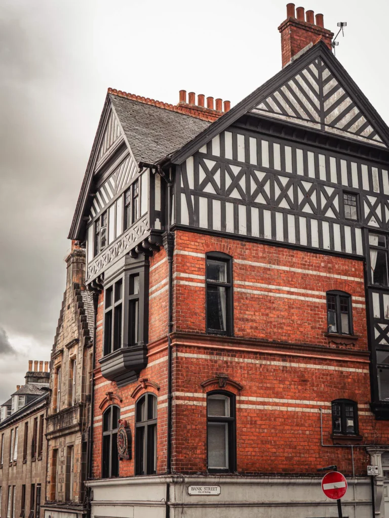 Red brick building with black and white timber framing, at the corner of Bank Street, in the old town of Stirling.